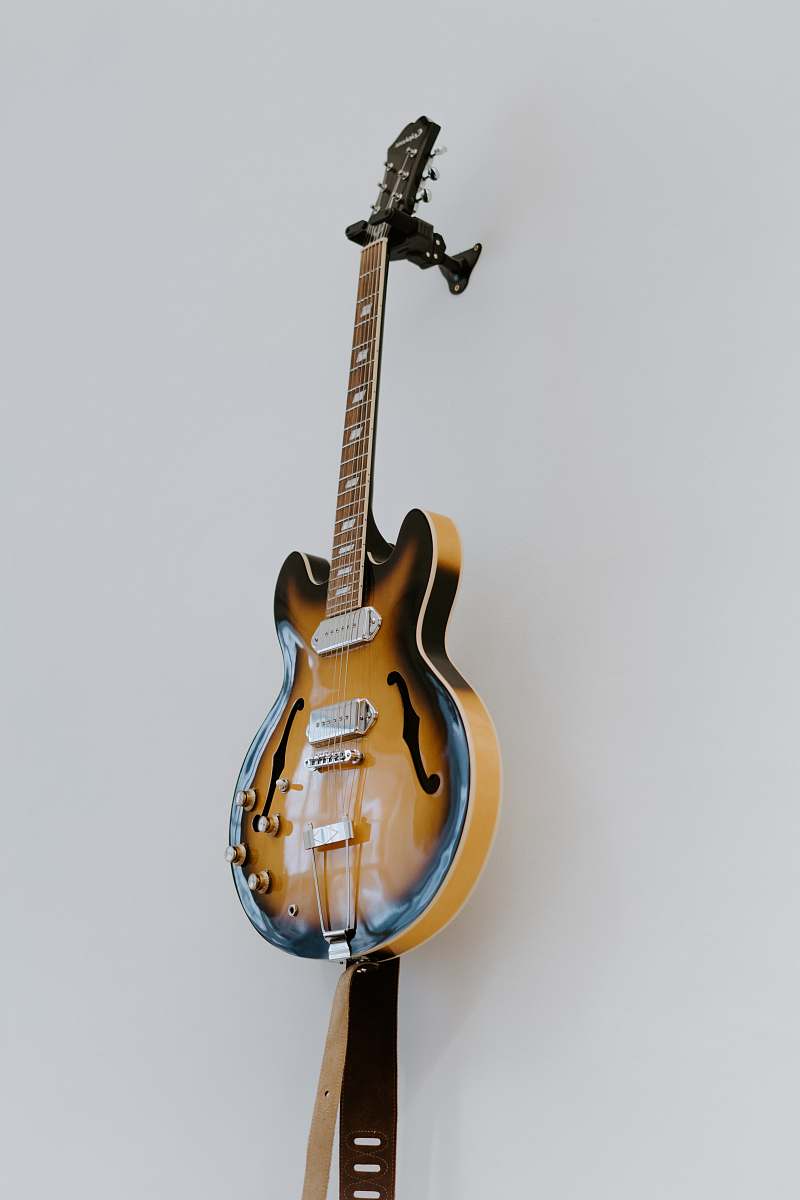 guitar brown electric guitar beside white wall leisure activities